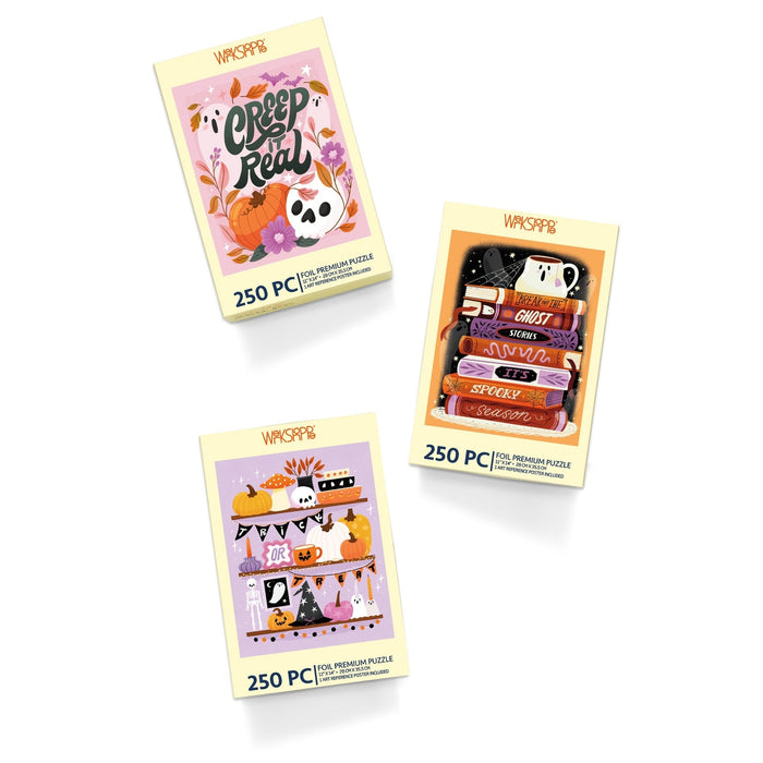 The WerkShoppe Creep It Real | 250 Piece Jigsaw Puzzle Set includes three festive Halloween puzzles, each presented in a yellow box with seasonal designs featuring pumpkins, books, and autumn decorations on a white background—an ideal fall gift for puzzle enthusiasts.