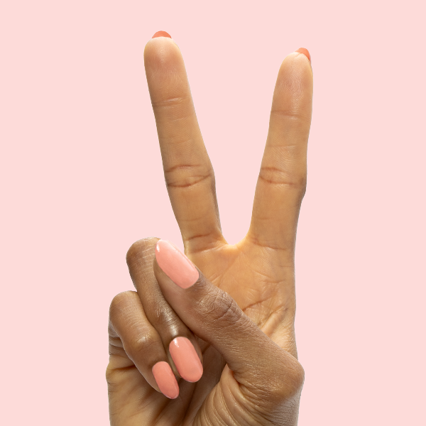 CS - Gel shown on natural nails in a smooth, petal-soft coral peach shade for an elegant at-home manicure look