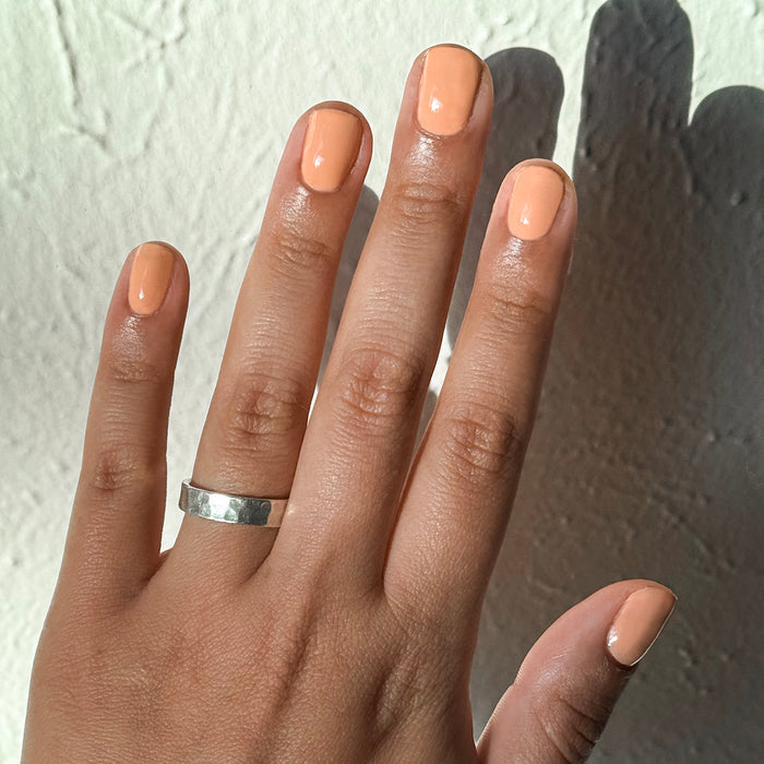 CS - Gel shown on natural nails in a smooth, petal-soft peach coral shade for a fresh at-home manicure look
