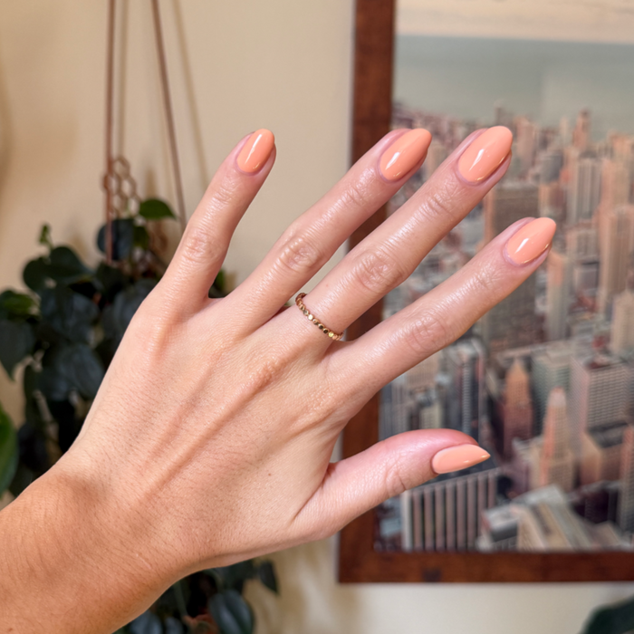 CS - Gel displayed on natural nails in a smooth, peachy coral shade for a clean at-home gel manicure look
