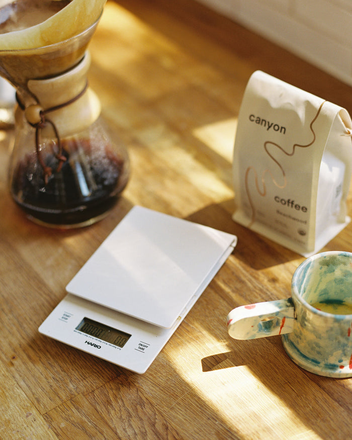 White coffee and kitchen scale by Hario with a chemex at home