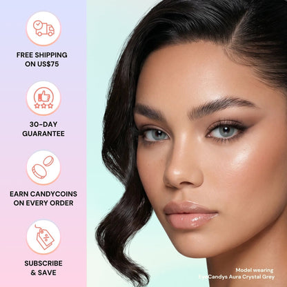 A woman with glowing makeup and wavy dark hair wears EyeCandys Aura Crystal Grey contacts. Beside her: icons and text—free shipping on US$75, 30-day guarantee, earn Candycoins, and subscribe & save.