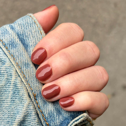 JJ - Gel polished on natural nails in a smooth cinnamon brown shade for a cozy, long-lasting manicure by Olive and June