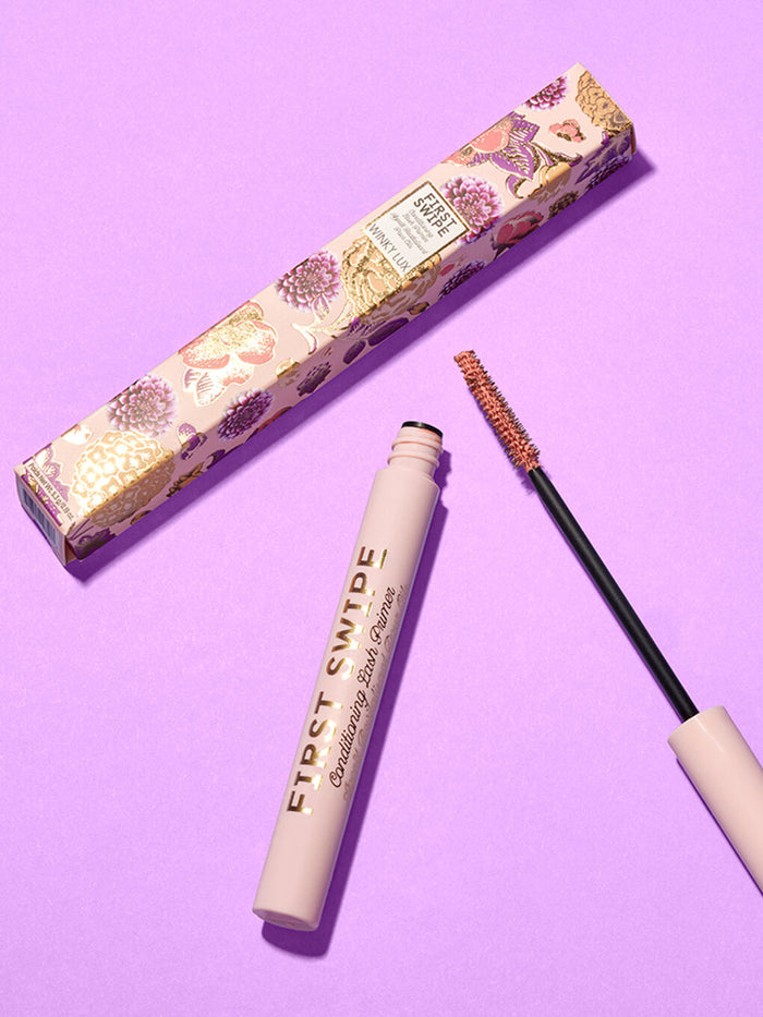 first swipe lash primer and box laying down on purple background