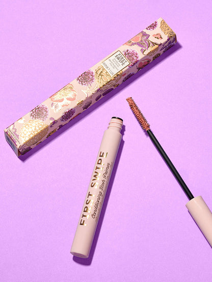first swipe lash primer and box laying down on purple background