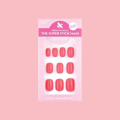 Flamingo | Extra Short | Squoval - Tab Press-On nails in neon pink shade on packaging against soft pink background