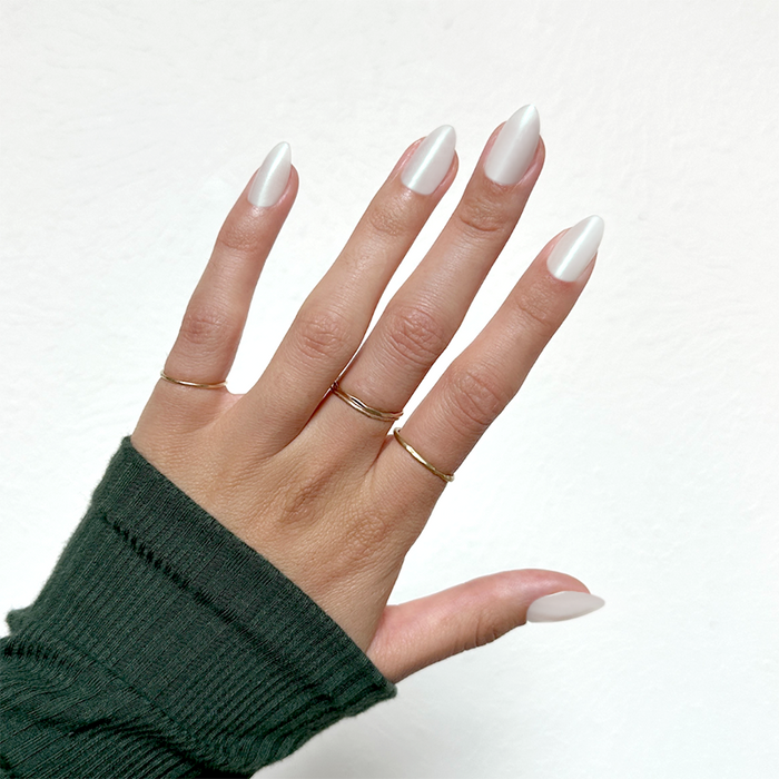 Girl With The Pearl Nail Polish - Press On | Medium | Almond medium oval iridescent sheer pearl manicure on hand with gold rings