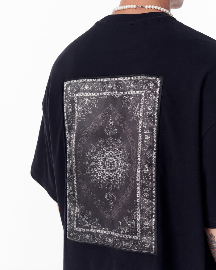 Martin Valen black oversized T‑shirt rear centered view showing rectangular gothic printed applique patch