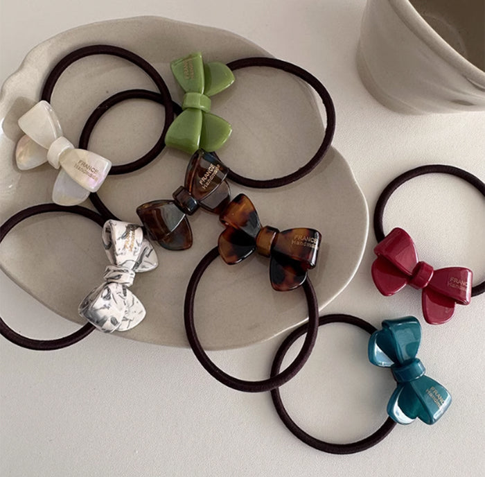 It is a functional and stylish accessory designed to secure your hair comfortably while adding a charming bow detail.