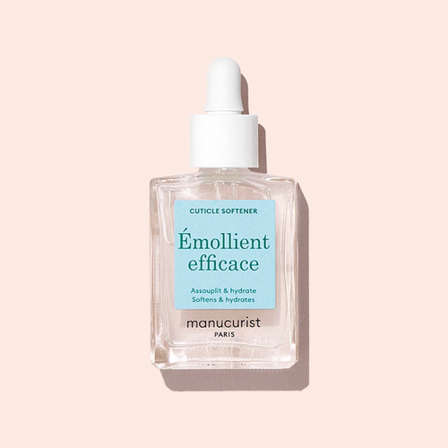 A clear glass dropper bottle of Manucurist Hydrating Cuticle Softener, featuring a white dropper cap and set against a light pink background—the perfect addition to your manicure routine.