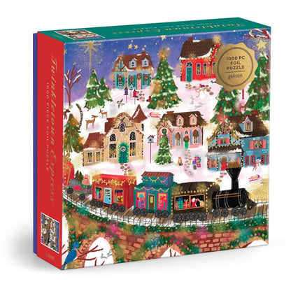 Box of the Joy Laforme Twinkletown Express 1,000 Piece Jigsaw Puzzle by Chronicle Books, featuring a vibrant holiday village scene with decorated houses, Christmas trees, and the festive Twinkletown Express train traveling through a snowy landscape.