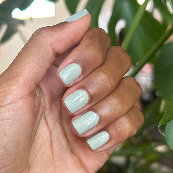 KMC - Gel shown on hand with smooth, pastel sage green nails for a fresh, long-lasting gel manicure by Olive and June