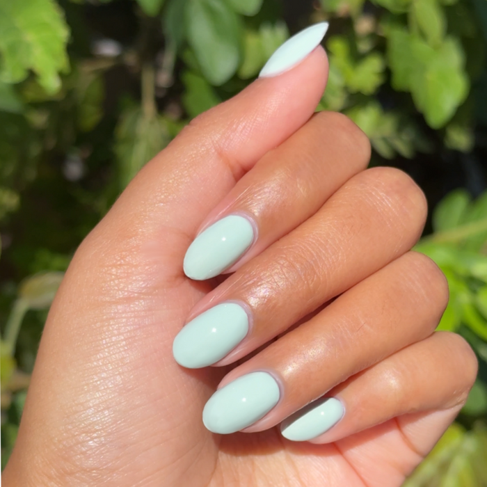KMC - Gel shown on hand with smooth light pastel green nails for a fresh, long-lasting gel polish manicure by Olive and June
