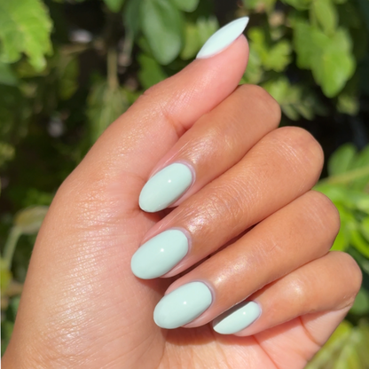 KMC - Gel shown on hand with smooth light pastel green nails for a fresh, long-lasting gel polish manicure by Olive and June