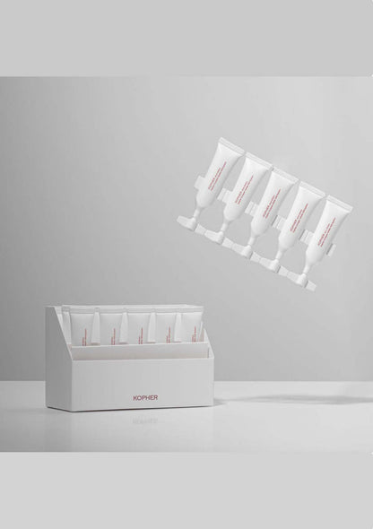 White skincare product packaging with multiple tubes on a gray background