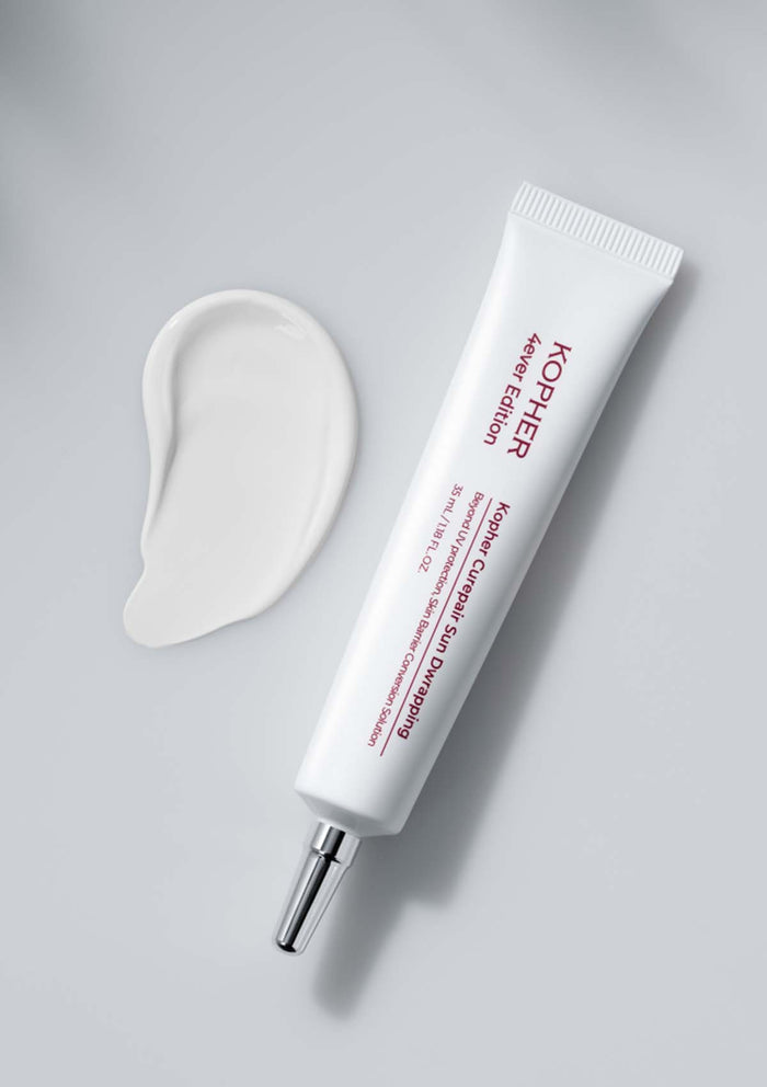 Kiehl's skincare product with applicator on a gray background