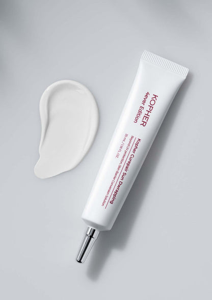 Kiehl's skincare product with applicator on a gray background