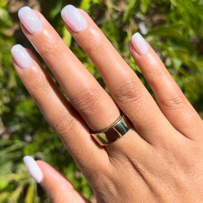 Lightning Strike | Extra Short | Squoval - Tab Press-On neutral nails with subtle white lightning bolt mani on hand outdoors