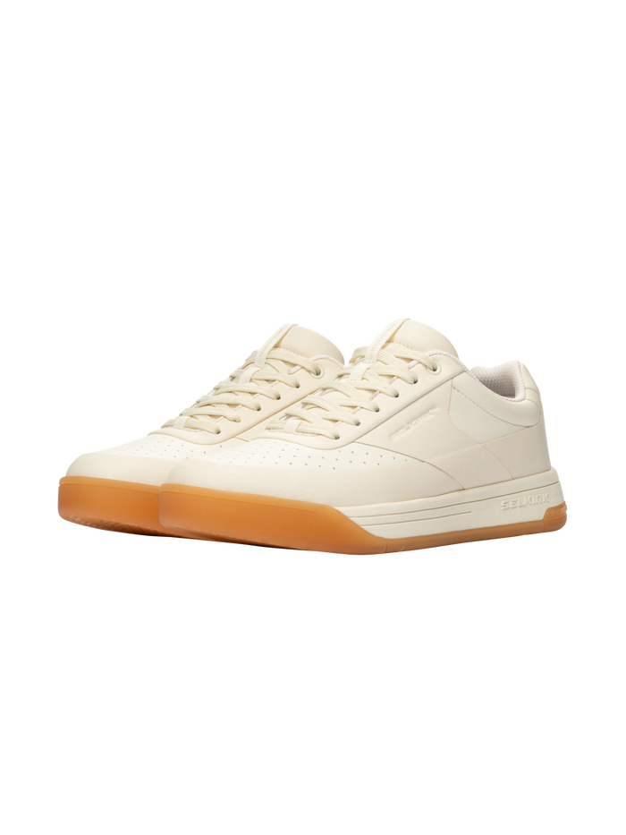 Three-quarter view of Selkirk Legacy Classic women’s pickleball shoes showcasing bone uppers and InfiniGrip gum outsoles