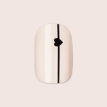 Linear Hearts | Short | Squoval - Tab Press-On neutral beige false nail with thin black line and small heart detail centered vertically