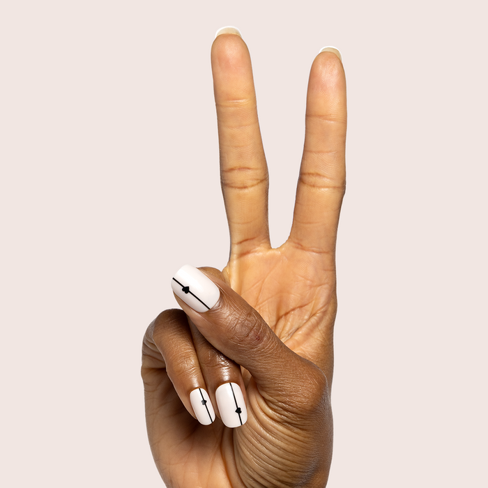 Linear Hearts | Short | Squoval - Tab Press-On white press-on nails with black linear hearts on fingers making peace sign