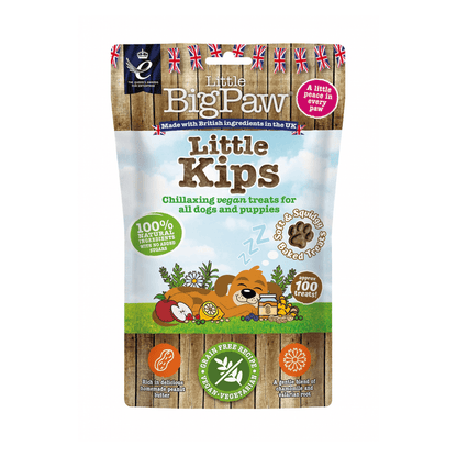 White background with a packet of Little BigPaw 'Little Kips' dog treats. Pictured on the packet is an illustration of a brown dog sleeping with a apples, berries, lemons and a jar of peanut butter in the foreground. Text on the bag says 'Chillaxing vegan treats for all dogs and puppies, 100% natural ingredients, soft & squidgy baked treats. Approx. 100 treats!'