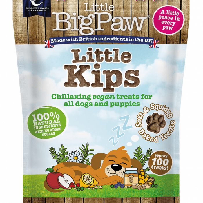 White background with a close up of a packet of Little BigPaw 'Little Kips' dog treats. Pictured on the packet is an illustration of a brown dog sleeping with a apples, berries, lemons and a jar of peanut butter in the foreground. Text on the bag says 'Chillaxing vegan treats for all dogs and puppies, 100% natural ingredients, soft & squidgy baked treats. Approx. 100 treats!'