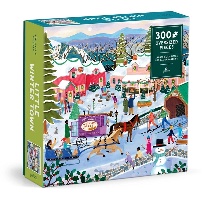 The Galison Little Winter Town | 300 Piece Jigsaw Puzzle features a vibrant winter village scene with people, a horse-drawn sleigh, snowy houses, and trees.