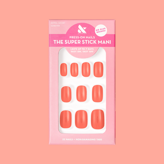 Lobster | Extra Short | Squoval - Tab Press-On nails in bright orangey red pink shown in packaging on coral background
