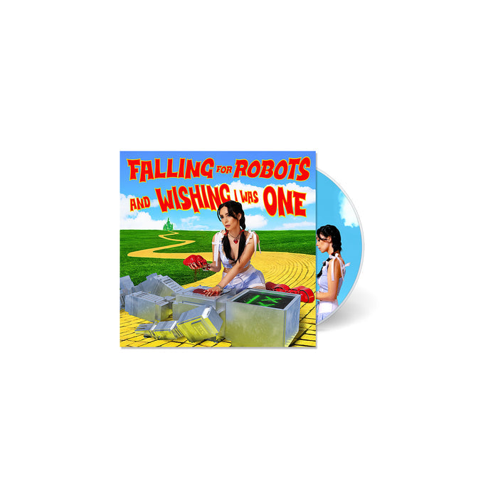 A CD cover from L0L0 shows a woman dressed as Dorothy from The Wizard of Oz beside robot parts on a yellow brick road, with the title Falling for Robots and Wishing I Was One in bold red and yellow text.