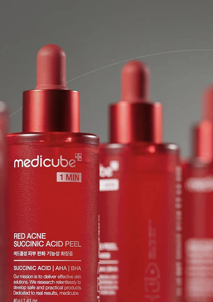 RedMedicube skincare product bottles on a gray background