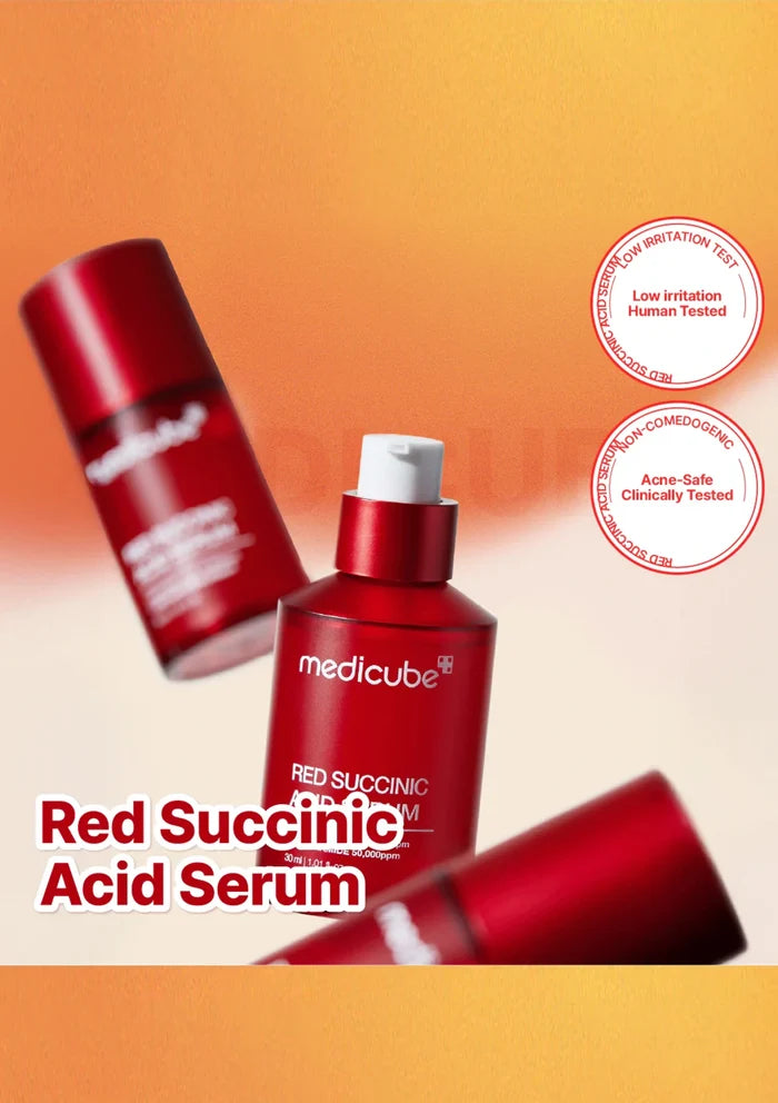 Red Succinic Acid Serum bottles with 'medicube' branding on an orange gradient background.