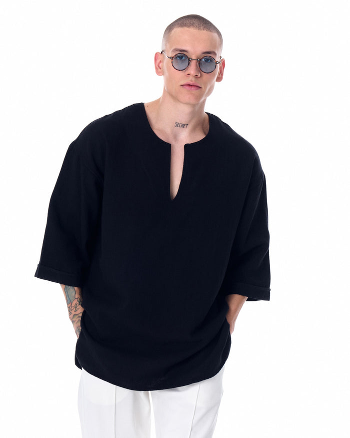 Martin Valen men's oversized black linen T-shirt shown on model, chest and face visible wearing round sunglasses
