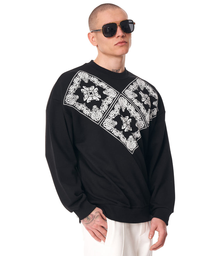 Martin Valen black men's oversized sweatshirt, midshot showing white V ethnic pattern and ribbed hem detail