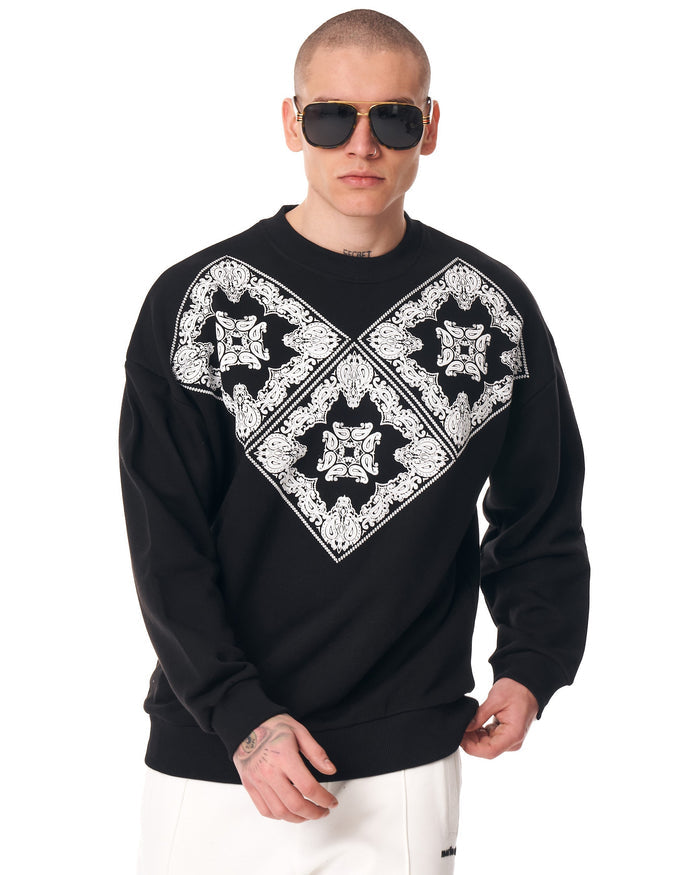 Martin Valen men's oversized black sweatshirt three-quarter rear view, ribbed hem and cuffs visible, model wearing sunglasses