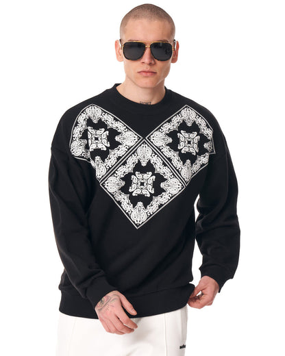 Martin Valen men's oversized black sweatshirt three-quarter rear view, ribbed hem and cuffs visible, model wearing sunglasses
