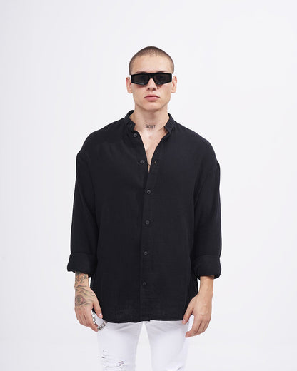 Martin Valen men’s oversized black linen mandarin-collar shirt, front view on model with rolled sleeves