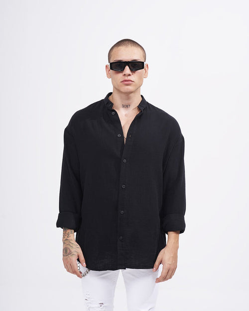Martin Valen men’s oversized black linen mandarin-collar shirt, front view on model with rolled sleeves