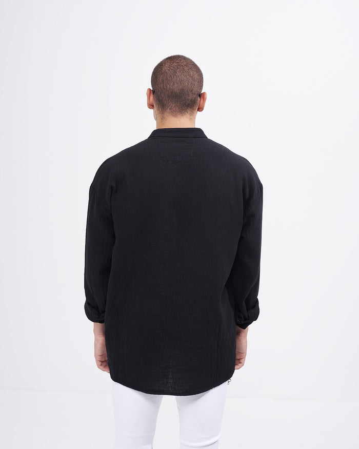Martin Valen oversized black linen mandarin-collar shirt, back view on model with rolled sleeves