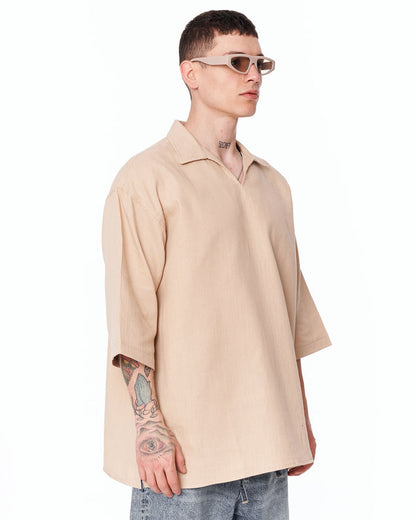 Martin Valen oversized beige linen shirt, three-quarter right view showing relaxed fit and dropped hem