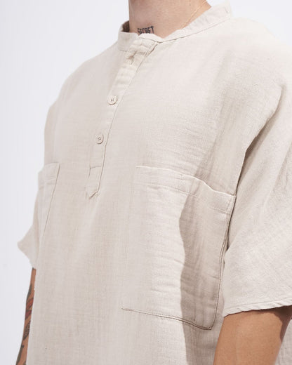 Martin Valen beige linen shirt close-up on chest showing half-button placket, mandarin collar and square front patch pockets
