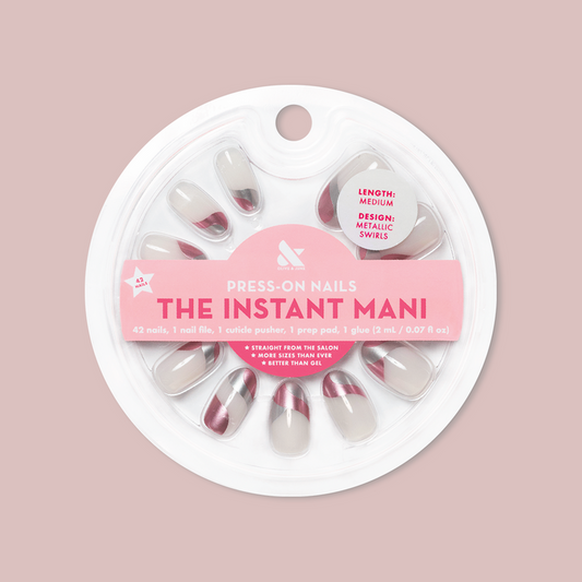 Metallic Swirls - Press-On | Medium | Oval false nails in two-tone metallic swirl design in circular packaging on soft pink background
