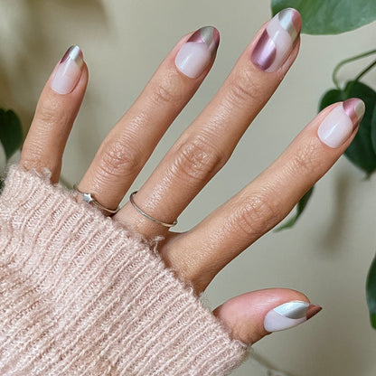 Hand with Metallic Swirls - Press-On | Medium | Oval false nails in two-tone metallic swirl design on natural skin tone
