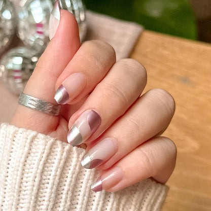 Metallic Swirls - Press-On | Medium | Oval natural nails with two-tone metallic pink and silver swirl design in soft indoor lighting