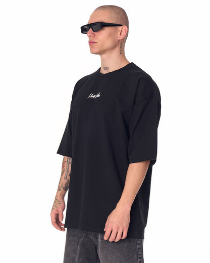 Martin Valen oversized black chest-printed T-shirt, close front view showing short sleeves and small white logo
