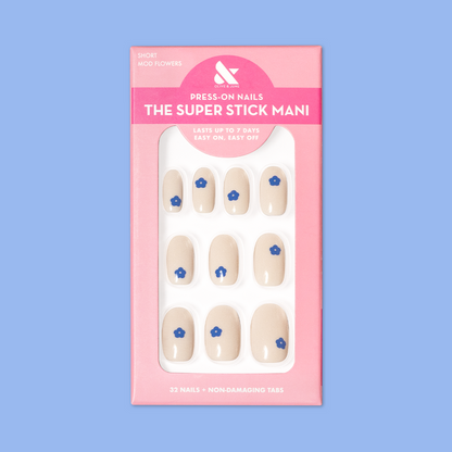 Mod Flowers | Short | Round - Tab Press-On nails in neutral polish with modern blue floral accents in pink packaging on blue background