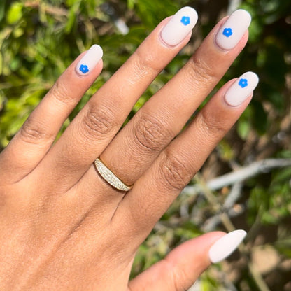 Mod Flowers | Short | Round - Tab Press-On nails with soft neutral polish and single modern blue flower detail on each nail outdoors
