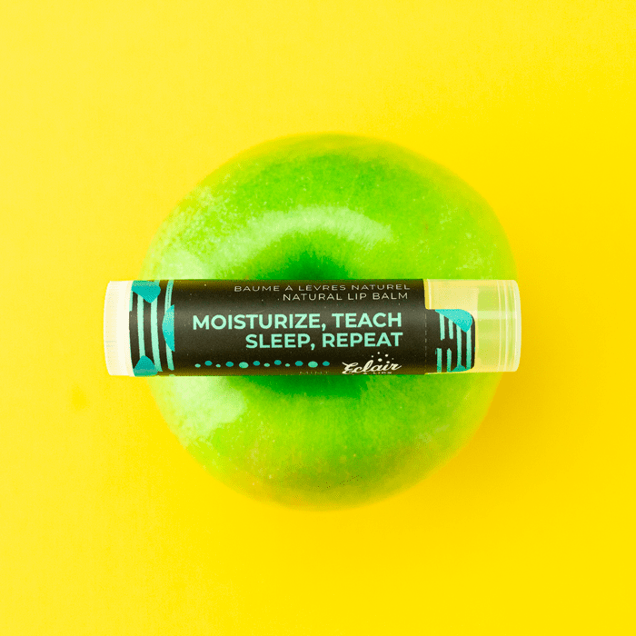 Natural lip balm on green apple