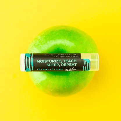 Natural lip balm on green apple