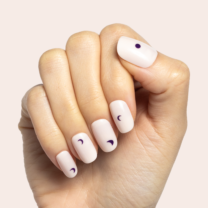 Moon Phases | Short | Squoval - Tab Press-On nails with soft neutral base and minimalist dark moon phase designs on hand